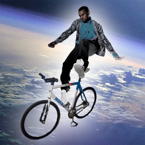 Kanye West shown here in orbital free fall, on a bicycle, wearing a grandpa cardigan.